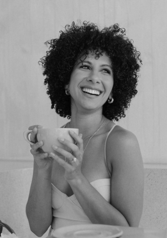 Woman holding a coffee cup and smiling